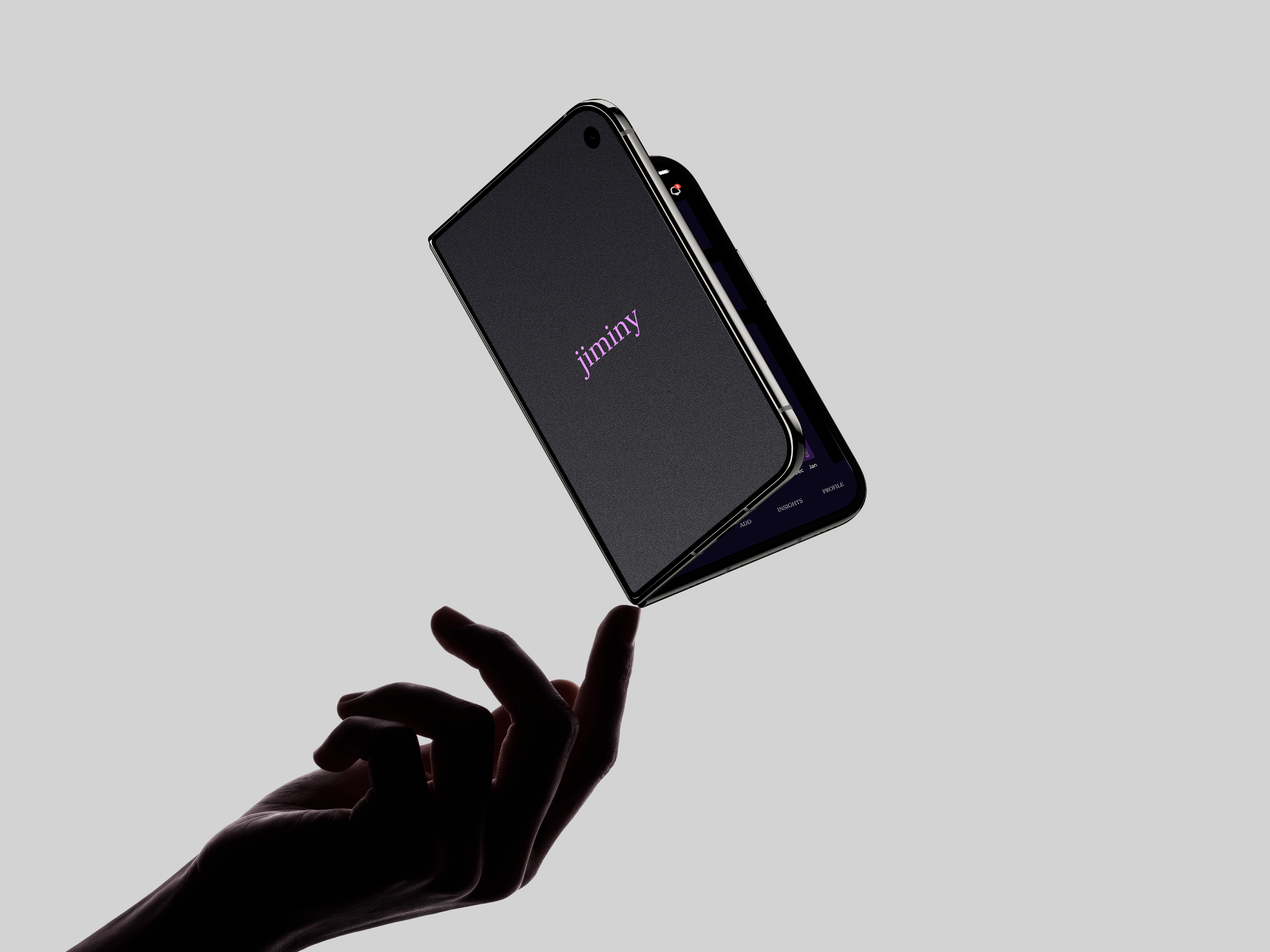 A hand holding a folded phone that shows the Jiminy logo
